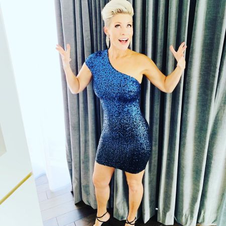 Rachel Reichard  in a blue dress poses a picture.